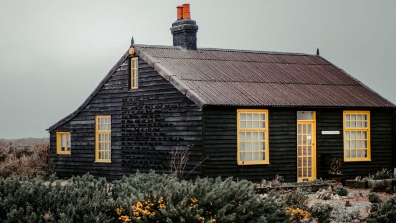A black and yellow wooden cabin in the middle of nowhere