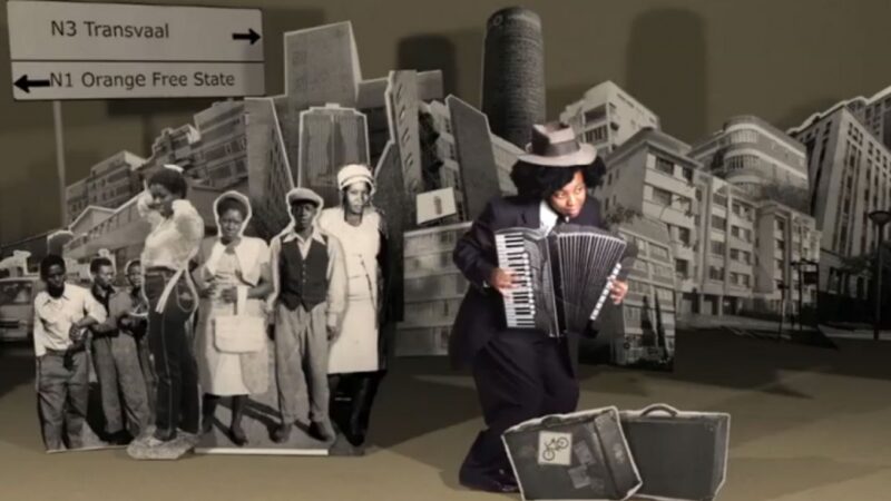 A person playing an accordion on a stage for Mandela Day