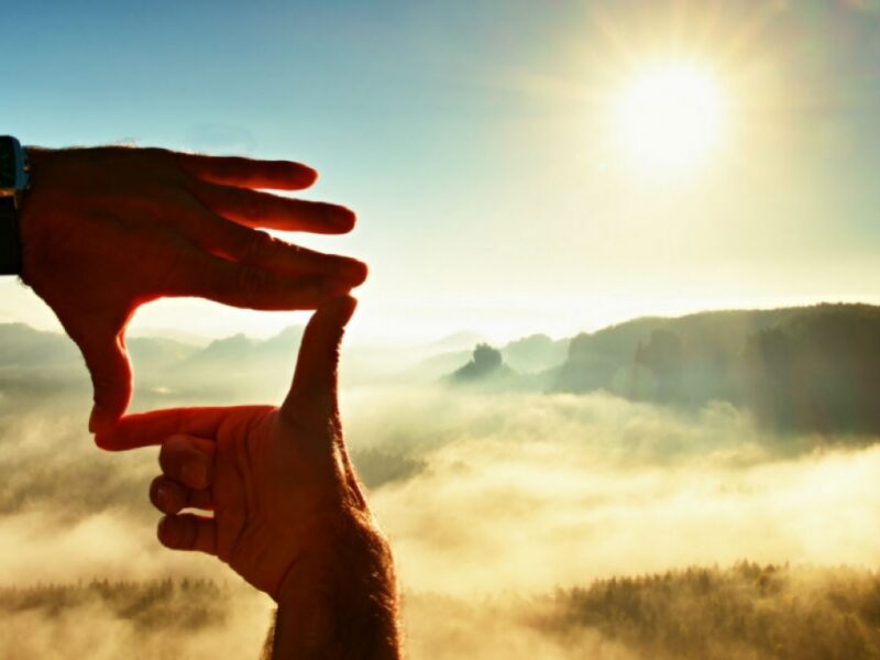 A pair pf hands in the air looking over the horizon