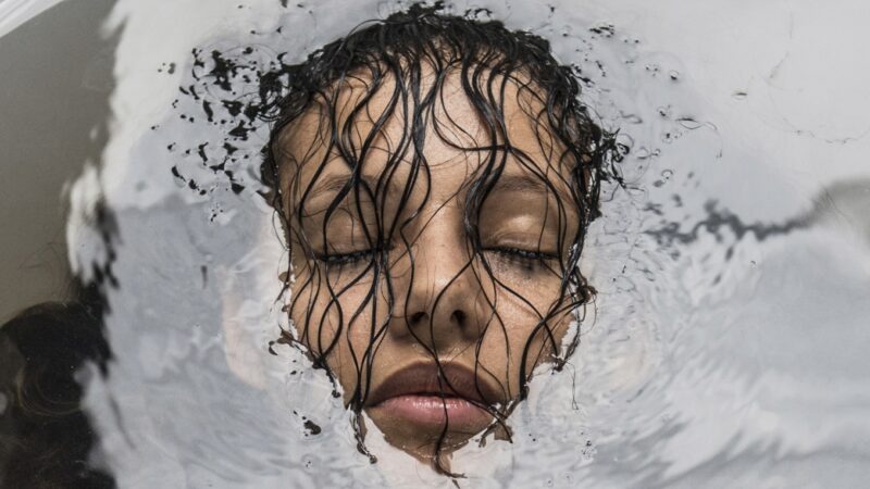 A still from Sink or Swim of a woman submerged in water