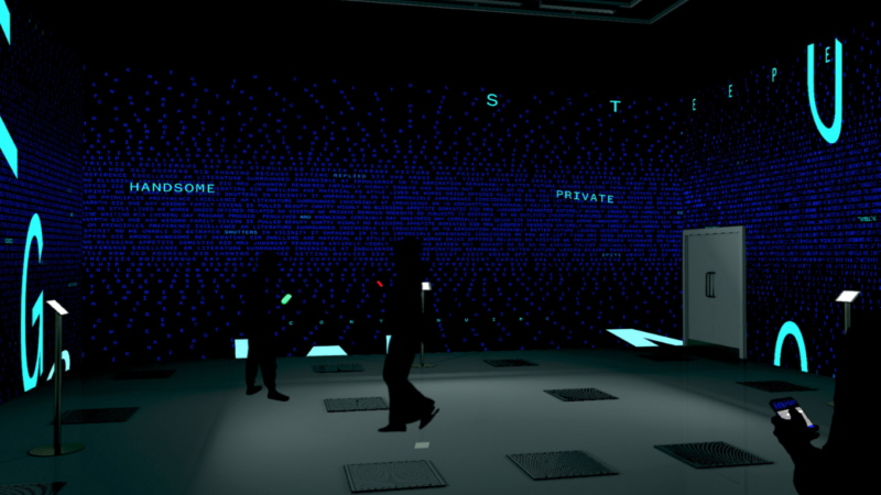 An animated image of a darkened empty room. A figure stands alone in the centre and the letters G and U are displayed randomly on the walls.