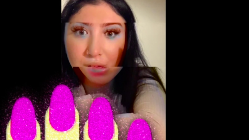 A still from Theatre Uncut present 'Bubble' of a woman on a glitched screen with the nail emoji on it