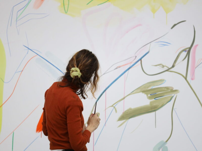 Artist France-Lise McGurn in front of a painting