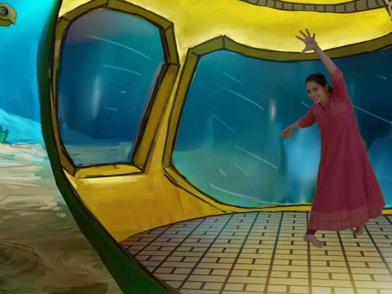 Female Asian dancer in a red dress dancing in front of an illustrated scene of the inside of a submarine on the ocean floor