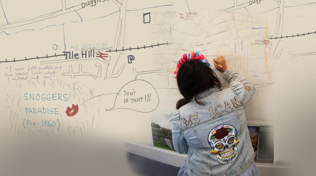 A person with dark hair sits down and writes on a whiteboard.