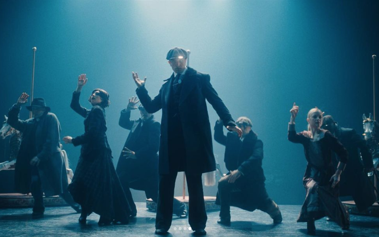 Scene from Rambert's dance film Peaky Blinders: The Redemption of Thomas Shelby. People on stage are dressed in 1940's clothing.