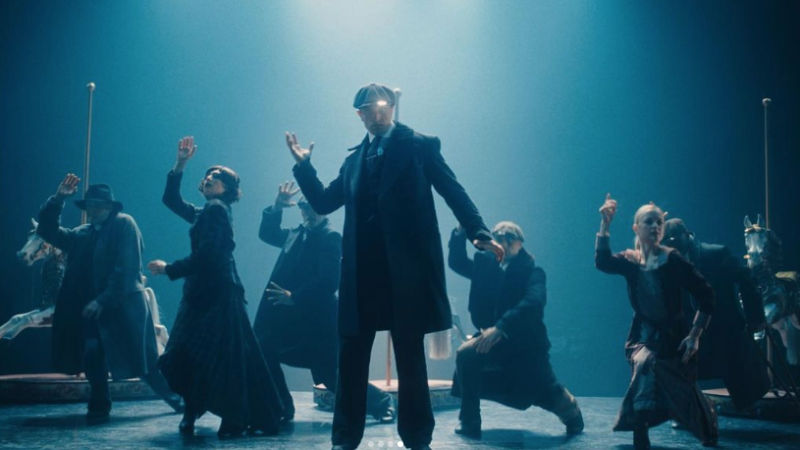 Scene from Rambert's dance film Peaky Blinders: The Redemption of Thomas Shelby. People on stage are dressed in 1940's clothing.