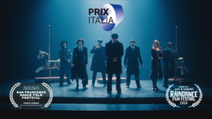 Scene from Rambert's dance film Peaky Blinders: The Redemption of Thomas Shelby. People on stage are dressed in 1940's clothing.