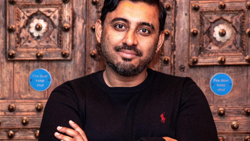 Abdul Shayek, a brown skinned man wearing a black top