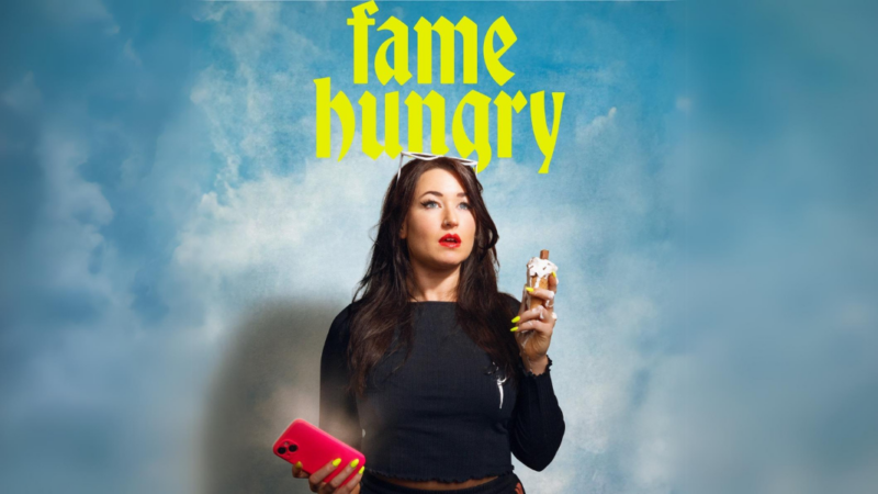 Louise Orwin holding a mobile phone and melting ice cream against a cloudy sky.