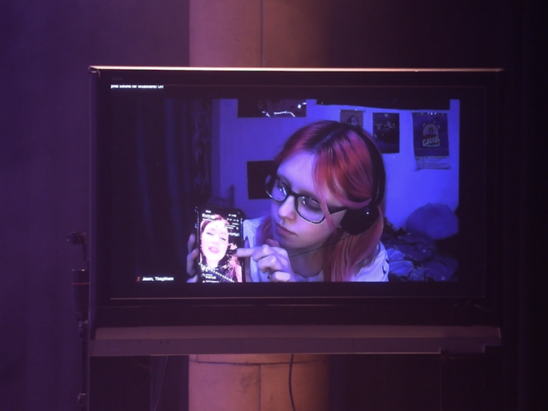 TikToker Jax holding up a mobile phone showing Lousie's Tik Tok live