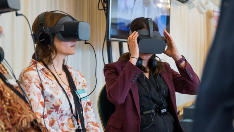 Photograph of three people with VR headsets on