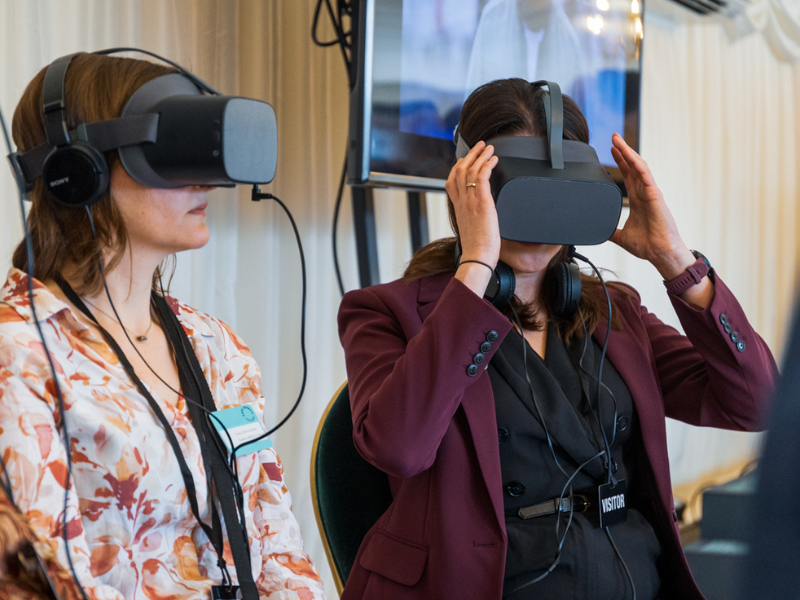 Photograph of three people with VR headsets on
