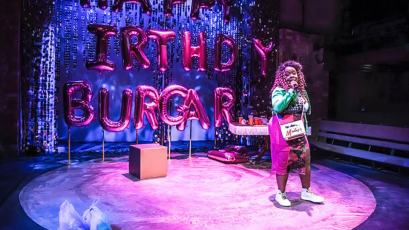 Photo from the stage show of the character Lady singing.